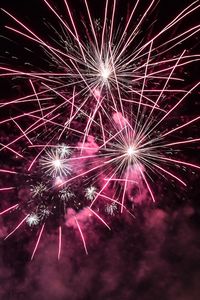 Low angle view of firework display at night