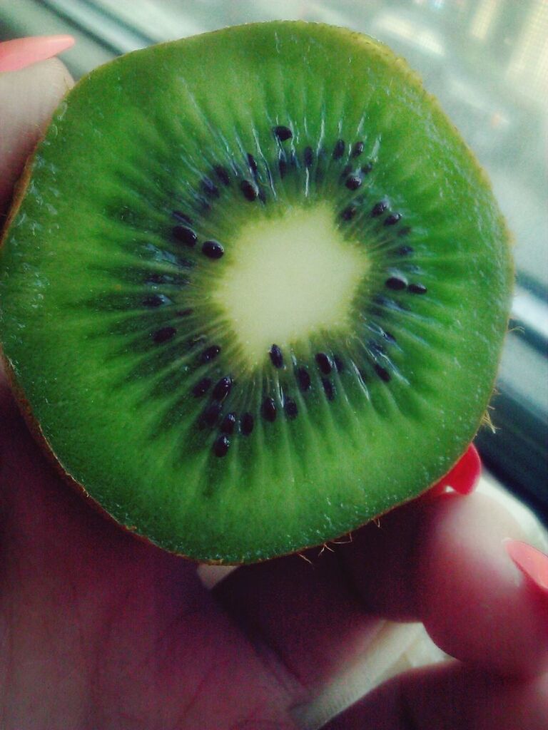 food and drink, freshness, close-up, fruit, indoors, food, cropped, healthy eating, green color, part of, person, holding, slice, high angle view, still life, focus on foreground, table