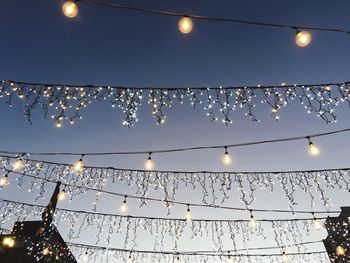 Low angle view of illuminated street light against sky at night