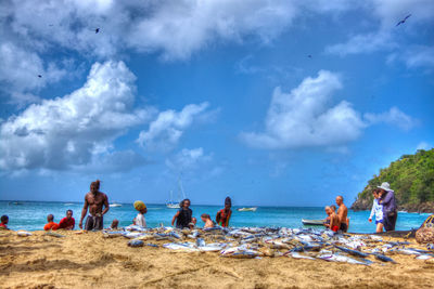 People on beach against sky