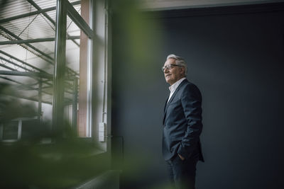 Senior businessman looking out of the window