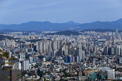 High angle view of modern buildings in city against sky