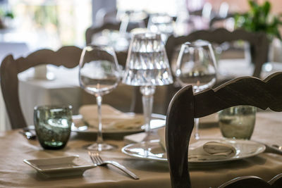 Close-up of wine glasses on table in restaurant