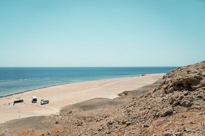 Tourism bus and cars house on beach from top view angle