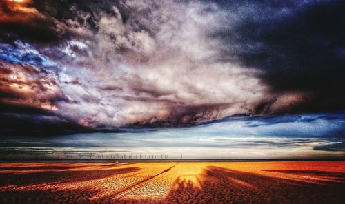 Scenic view of sea against dramatic sky