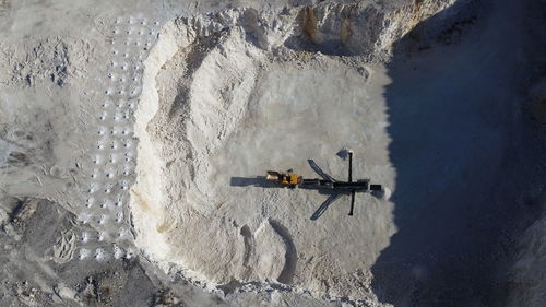 High angle view of man walking on snow