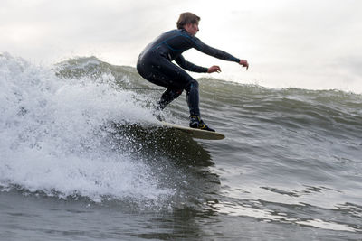 Full length of man splashing water in sea
