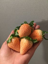 Close-up of hand holding strawberries