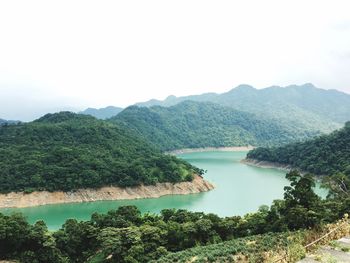 High angle view of river amidst trees against sky