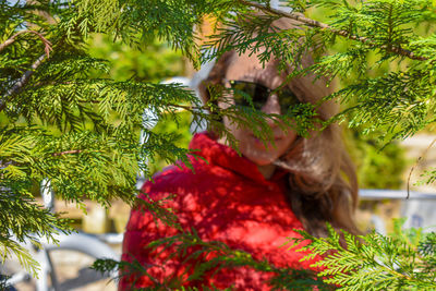 Portrait of woman with plants in park