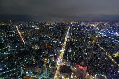 High angle view of illuminated city buildings at night