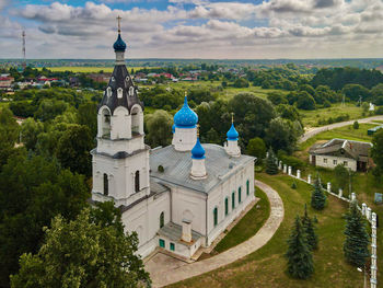 Panoramic view of trees and buildings against sky