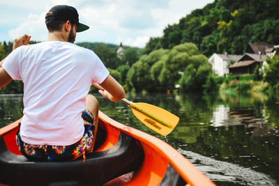 Rear view of man standing in lake