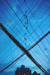 Low angle view of modern building against cloudy sky