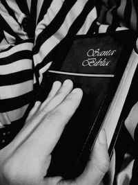 Close-up of hand holding book