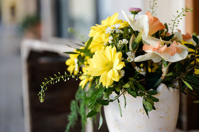 Close-up of yellow flowering plant in vase