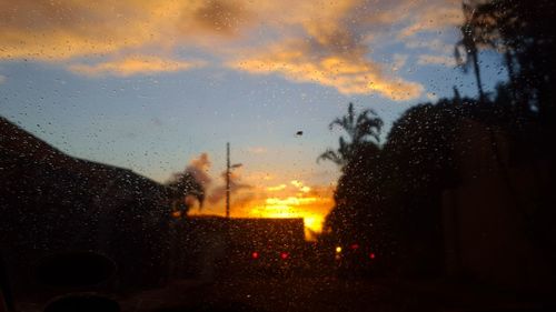 Wet street against sky during rainy season