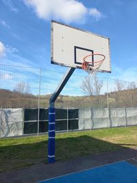 Low angle view of road sign against sky