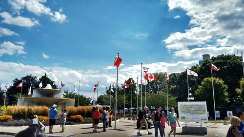 People in park against cloudy sky