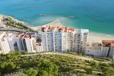 High angle view of buildings and sea in city