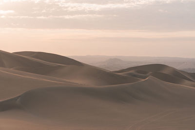 Scenic view of desert against sky during sunset