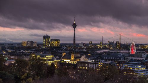 Buildings in city against cloudy sky