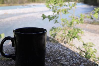 Close-up of coffee cup on retaining wall