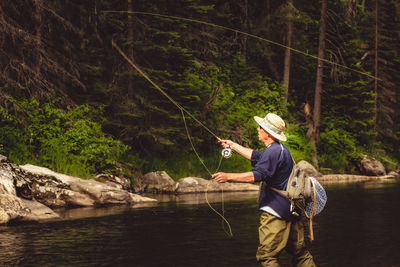 Full length of man fishing in lake