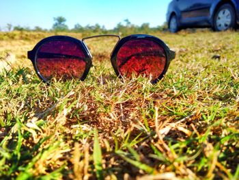 Close-up of sunglasses on field