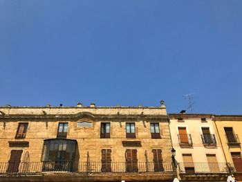 Low angle view of building against clear blue sky