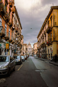 Main street of catania with the facade of its cathedral in the background