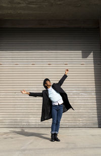 Full length of man with arms raised