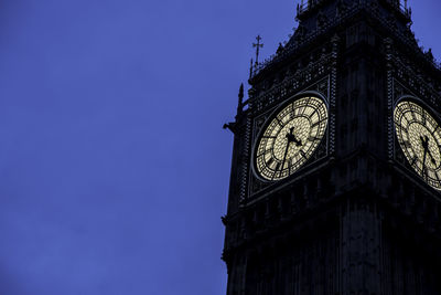 Low angle view of clock tower against clear sky