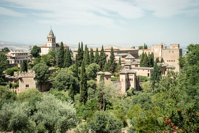 Panoramic view of trees and buildings against sky