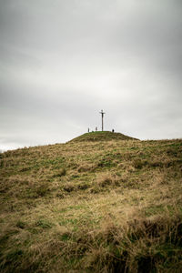 Cross on top of a mountain peak with jesus christ