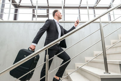 Businessman walking on staircase