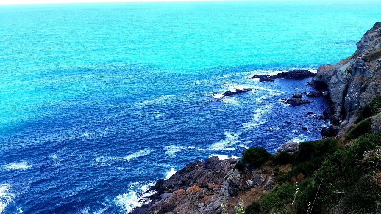 sea, water, blue, scenics, tranquil scene, tranquility, beauty in nature, horizon over water, nature, coastline, seascape, idyllic, cliff, rippled, rock - object, rock formation, turquoise colored, day, outdoors, ocean, rock, no people, elevated view, remote, non-urban scene, calm, travel destinations, non urban scene, sky