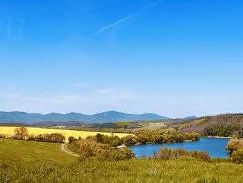 Scenic view of landscape against blue sky