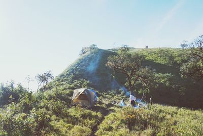 People in tent against clear sky