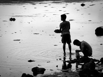 Rear view of two people on water