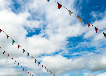 Multi-color triangle flag hanging on the rope and blue sky