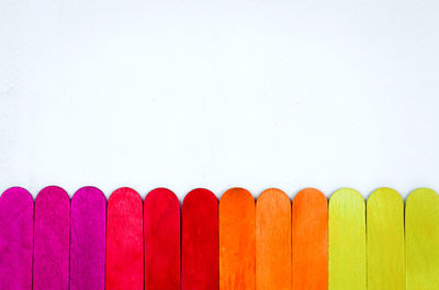 Close-up of multi colored pencils against white background