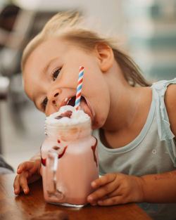 Girl eating ice cream on table