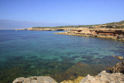 Scenic view of sea against clear blue sky