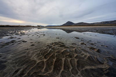 Wetland and mountains in cloudy evening