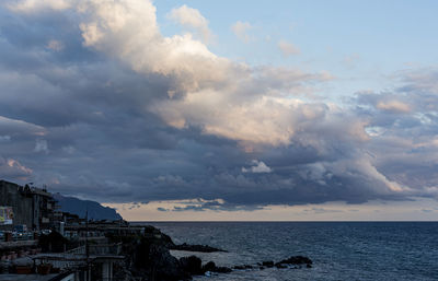 Scenic view of sea and buildings against sky