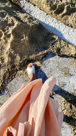 Low section of woman standing on beach