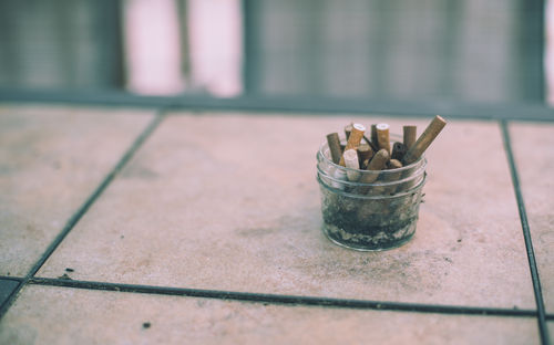 Close-up of cigarette smoking on floor