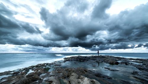 Scenic view of sea against cloudy sky