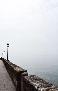 Street by sea against sky